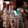 Durable liquor travel case with padded compartments safely carrying multiple liquor bottles for secure transport