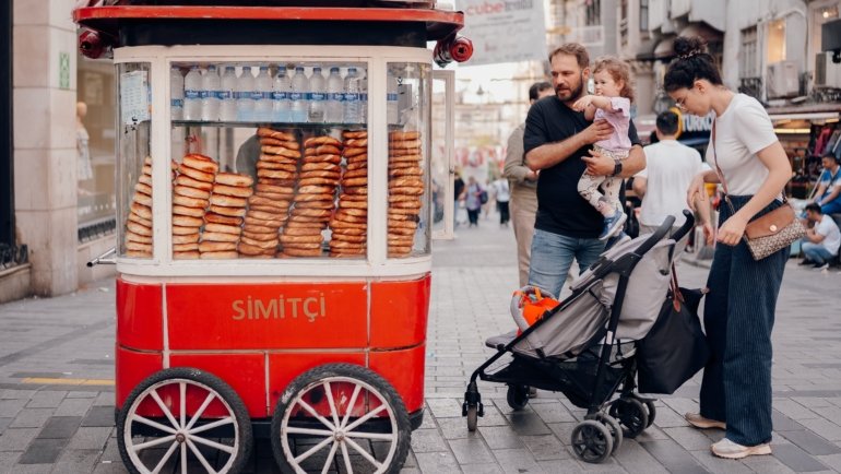 Family traveling with a toddler in stroller enjoying a safe and child-friendly outdoor destination