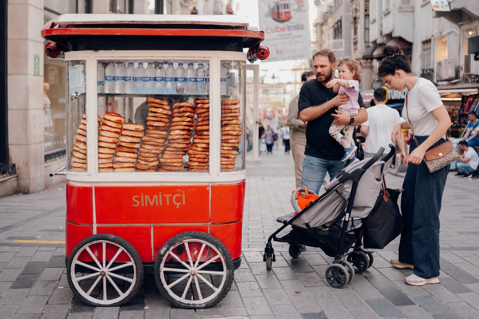 Family traveling with a toddler in stroller enjoying a safe and child-friendly outdoor destination
