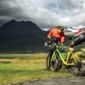 Cyclist packing bike into a protective EVOC travel case ready for secure transportation