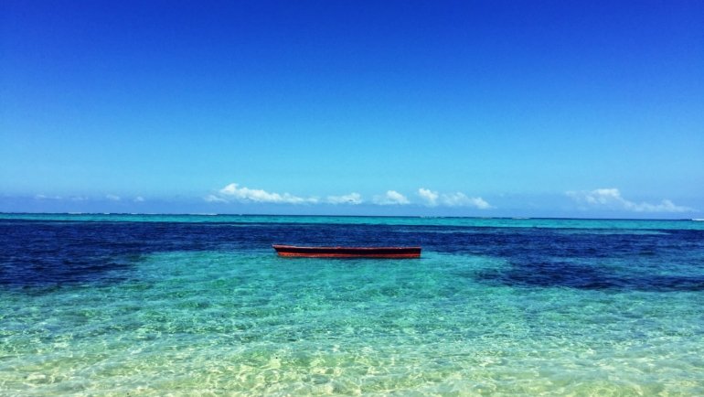 Crystal clear blue ocean waters at a peaceful beach showcasing natural beauty and tranquility for blue travel destinations