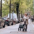 Elderly traveler using a collapsible walker outdoors for easy mobility and travel support