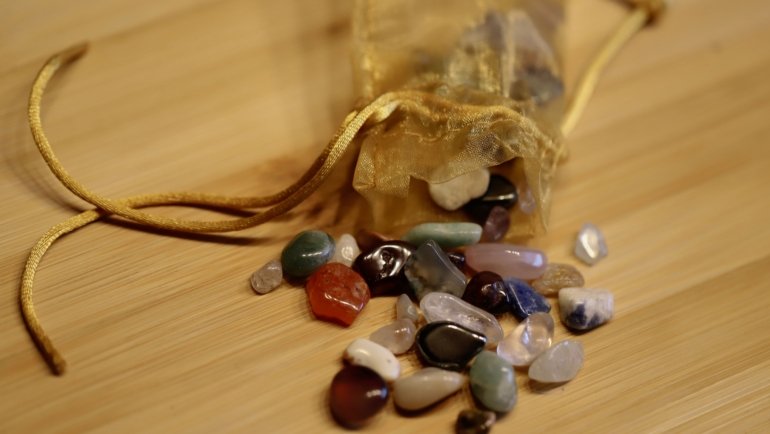 Travel pouch with protective and calming crystals on natural surface for peaceful and mindful travel