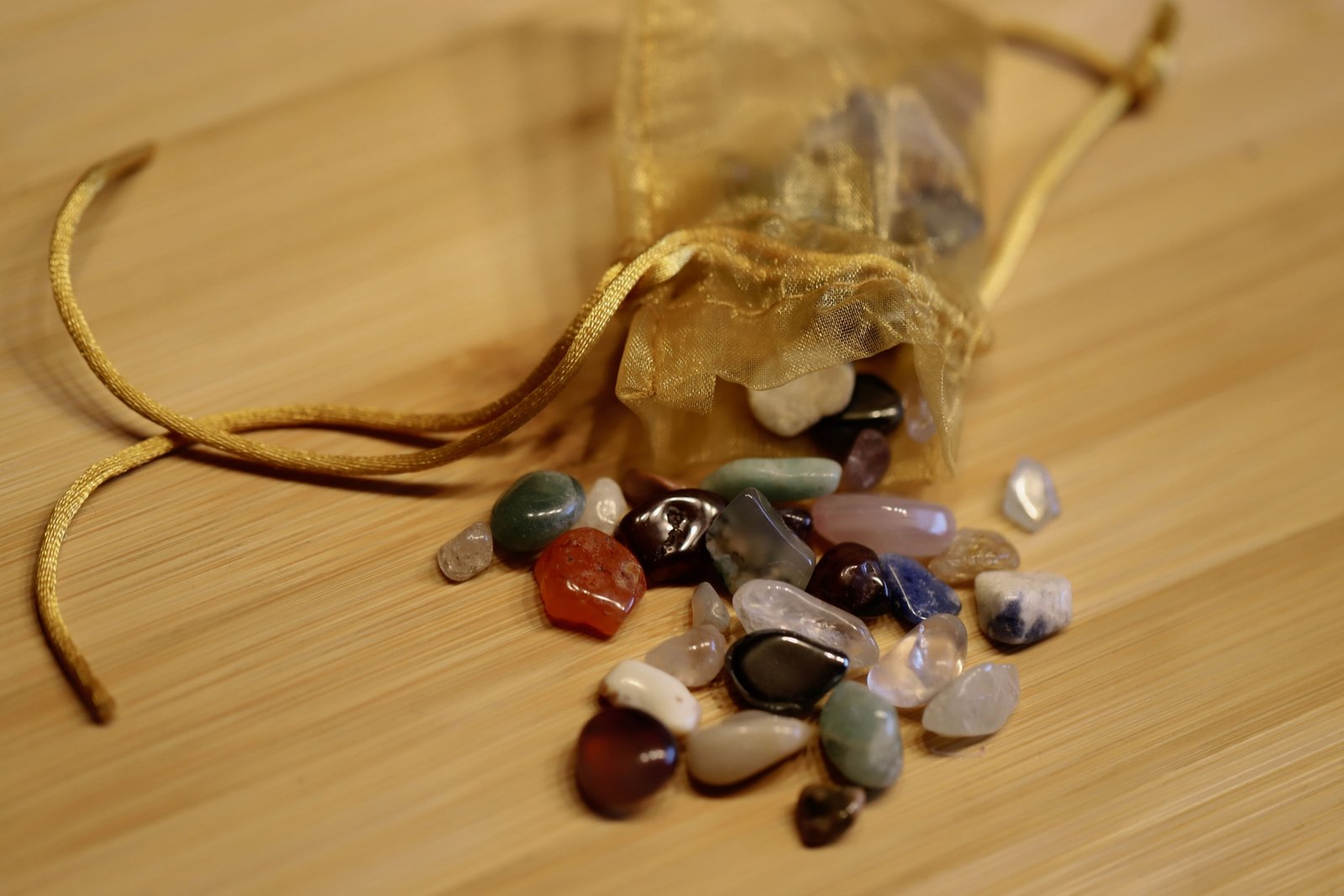 Travel pouch with protective and calming crystals on natural surface for peaceful and mindful travel