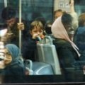 Diverse group of happy passengers enjoying free bus travel in a city bus