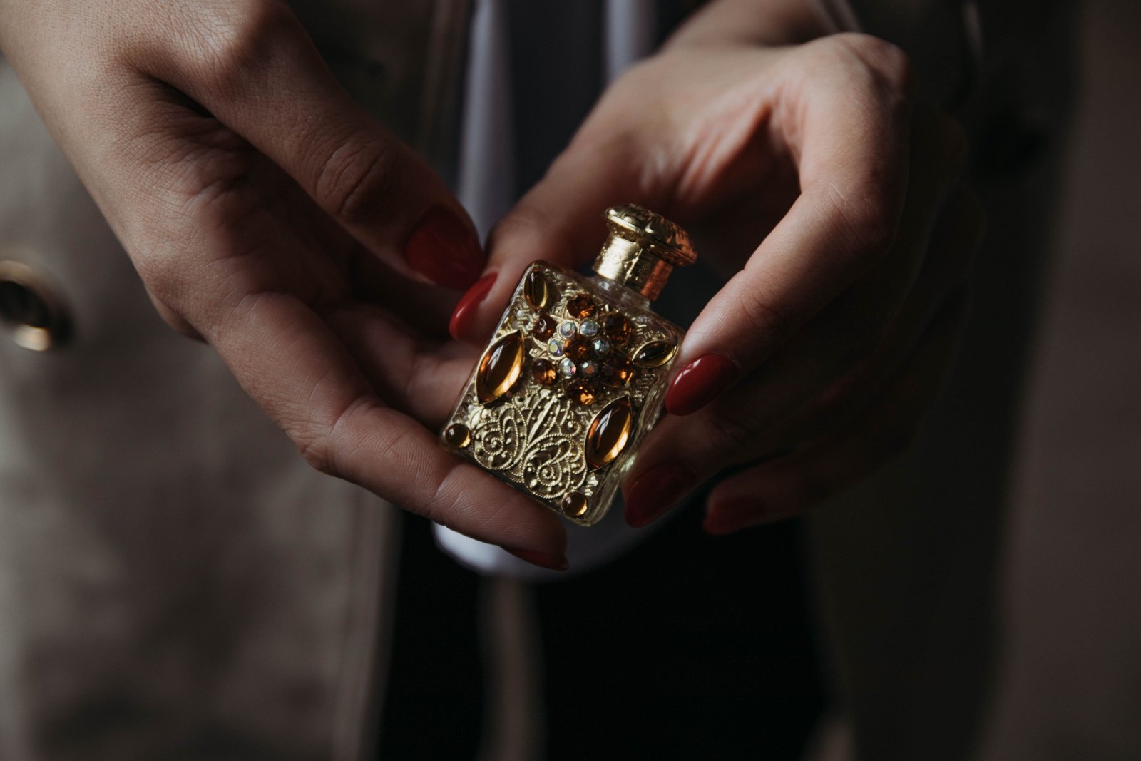 Delina perfume travel size bottle next to a purse, showcasing a luxury fragrance perfect for travel and daily freshness