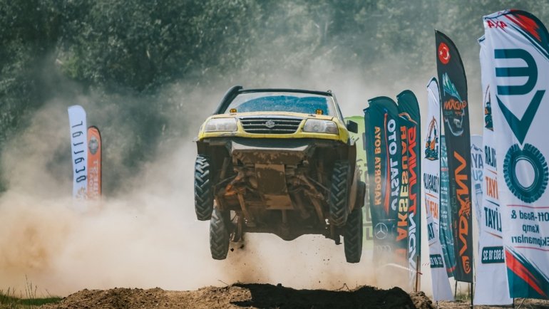 Close-up of long travel shock absorber on an off-road vehicle tackling rocky terrain for improved suspension and ride quality