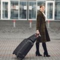 Durable modern roller travel suitcase with 360-degree spinner wheels at airport terminal