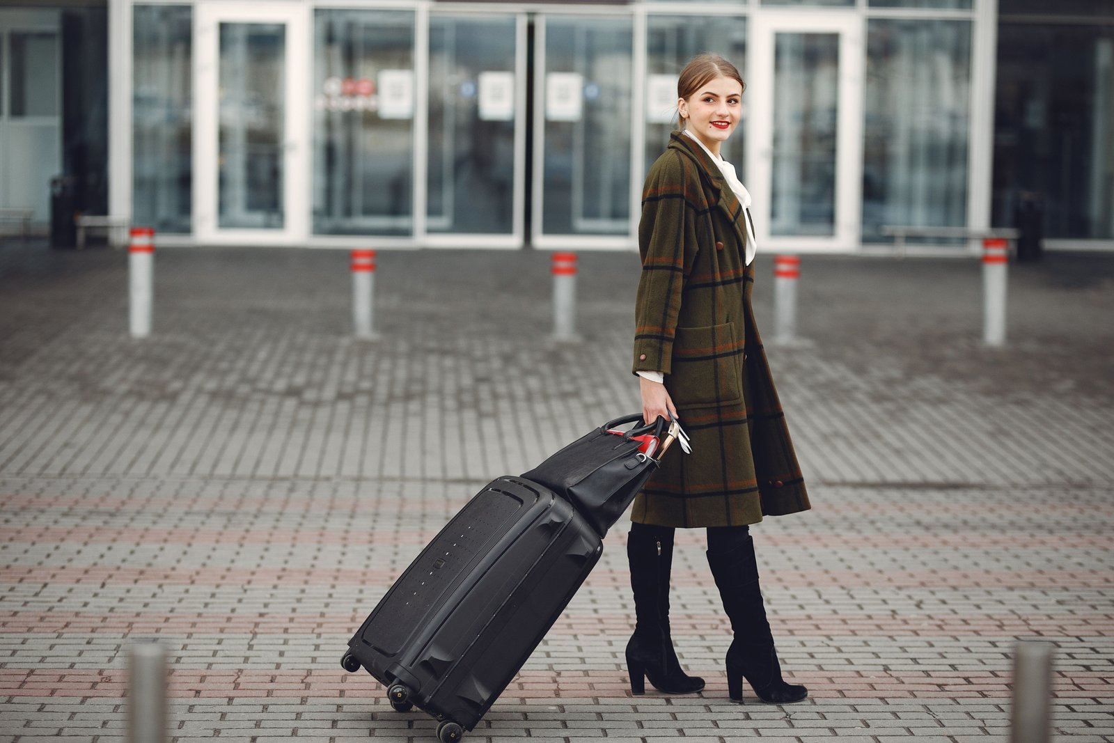 Durable modern roller travel suitcase with 360-degree spinner wheels at airport terminal