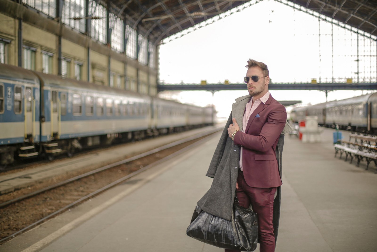 Stylish traveler with a lightweight mini travel bag walking in the city for a weekend trip