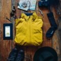 Close-up of a national parks travel map with hiking gear, compass, and boots representing trip planning and outdoor adventure