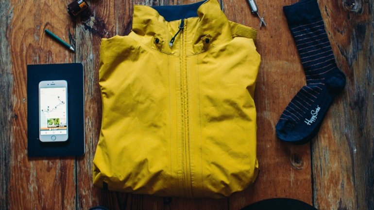 Close-up of a national parks travel map with hiking gear, compass, and boots representing trip planning and outdoor adventure