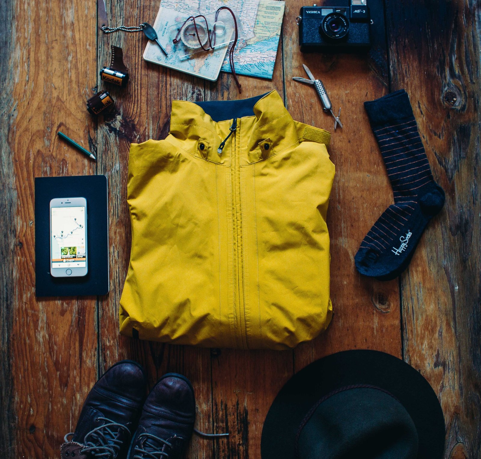 Close-up of a national parks travel map with hiking gear, compass, and boots representing trip planning and outdoor adventure