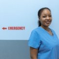 Emergency room nurse in Kansas City hospital providing care during busy shift for travel nursing assignment