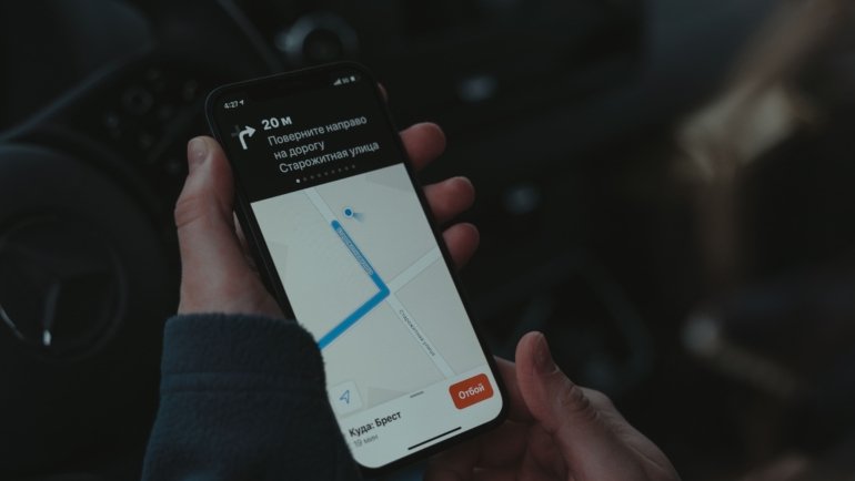 Business employee using GPS tracking on smartphone for travel safety and location monitoring