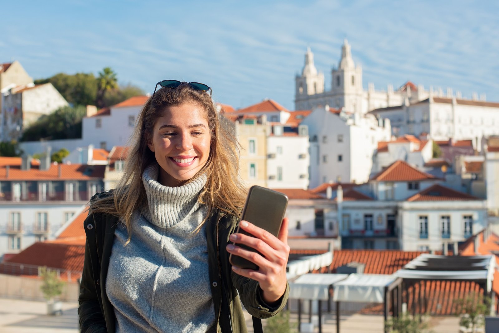 Traveler using discount code on smartphone during half day city tour saving money