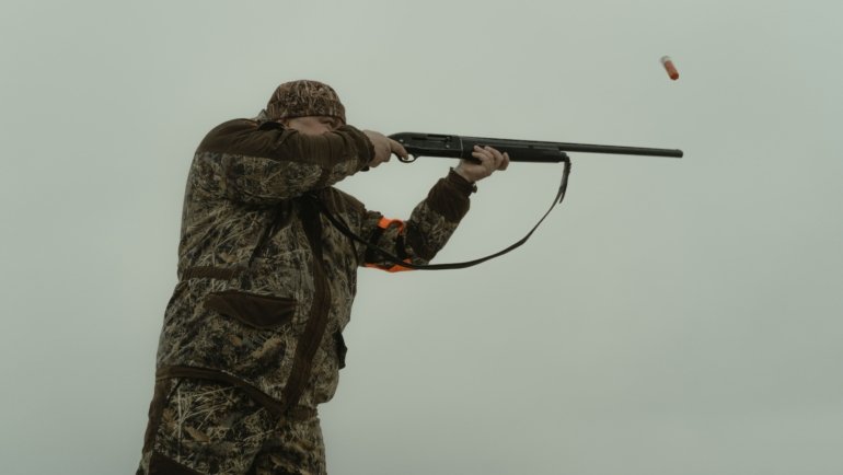 Shotgun shooting bird shot pellets outdoors demonstrating effective hunting range and pellet spread