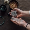 Travel protection crystals including amethyst and black tourmaline next to a suitcase symbolizing spiritual safety and calm during journeys