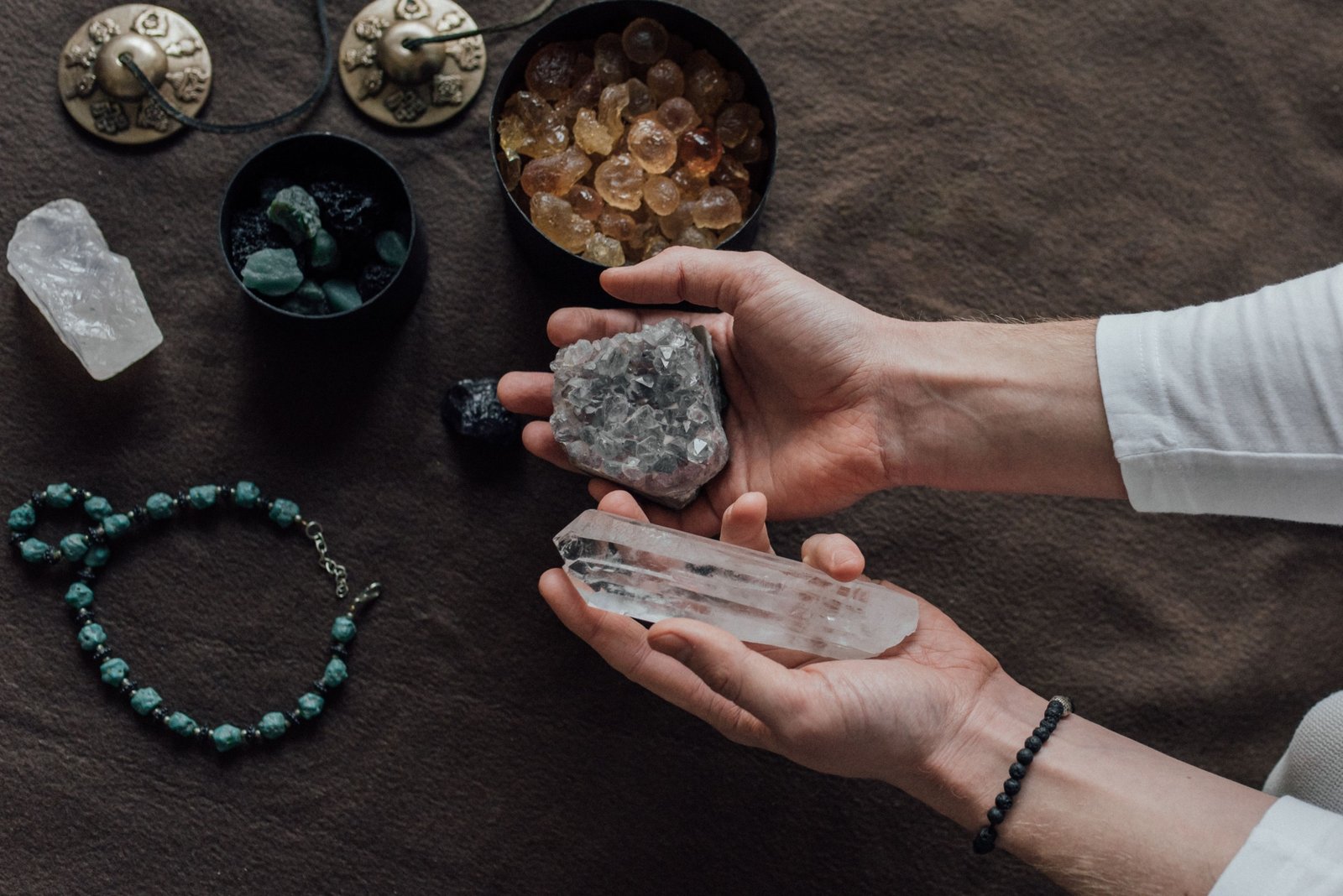Travel protection crystals including amethyst and black tourmaline next to a suitcase symbolizing spiritual safety and calm during journeys