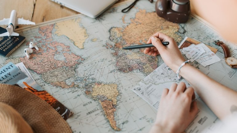 Travel agent helping customer plan trip with flight and hotel booking at travel center