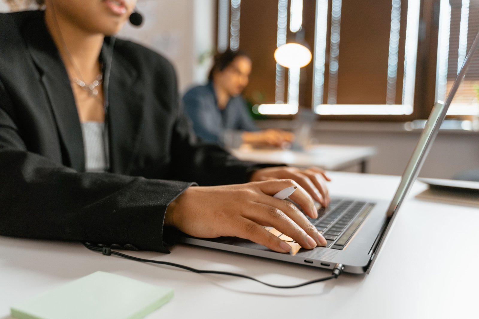 Travel agent using laptop to manage bookings and access travel portal