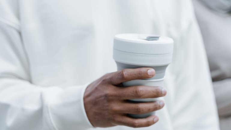 Folding travel cup collapsing and expanding, perfect for eco-friendly and portable hydration on the go
