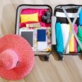 Baseball cap stored safely in a protective travel bag inside an open suitcase, highlighting organized and secure packing for travel