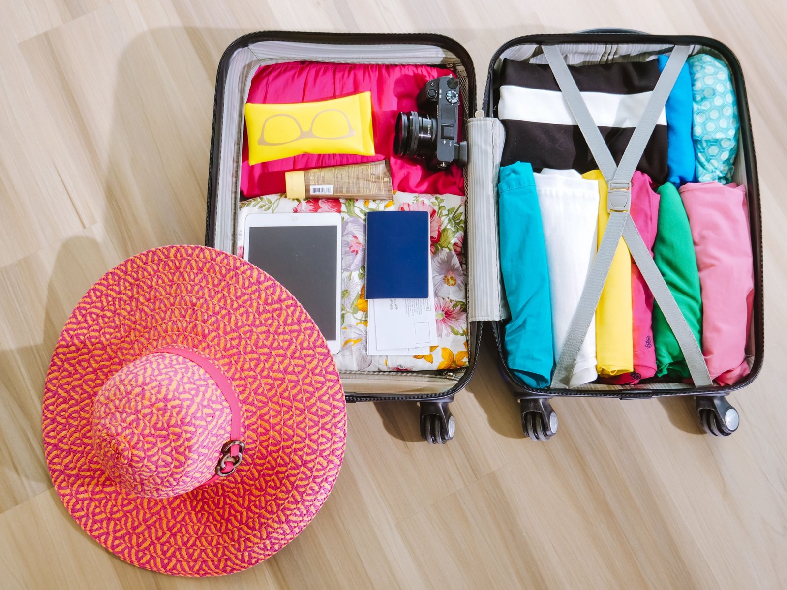 Baseball cap stored safely in a protective travel bag inside an open suitcase, highlighting organized and secure packing for travel