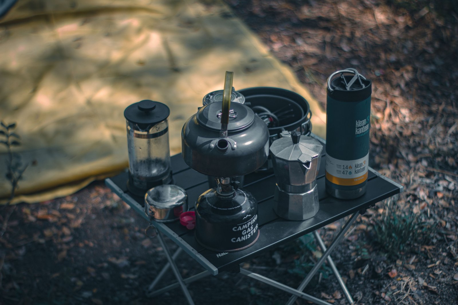 Coffee press travel mug with fresh brewed coffee, perfect for outdoor use and eco-friendly travel