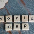 Person learning Spanish travel vocabulary with map and notebook for effective language translation