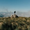 Traveler enjoying breathtaking landscape on an adventurous journey, inspiring wanderlust and cultural exploration