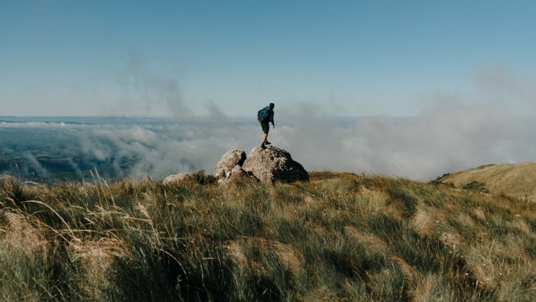 Traveler enjoying breathtaking landscape on an adventurous journey, inspiring wanderlust and cultural exploration