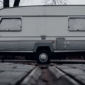 Classic Shasta retro travel trailer parked in nature, showcasing vintage aluminum exterior and cozy camping setup