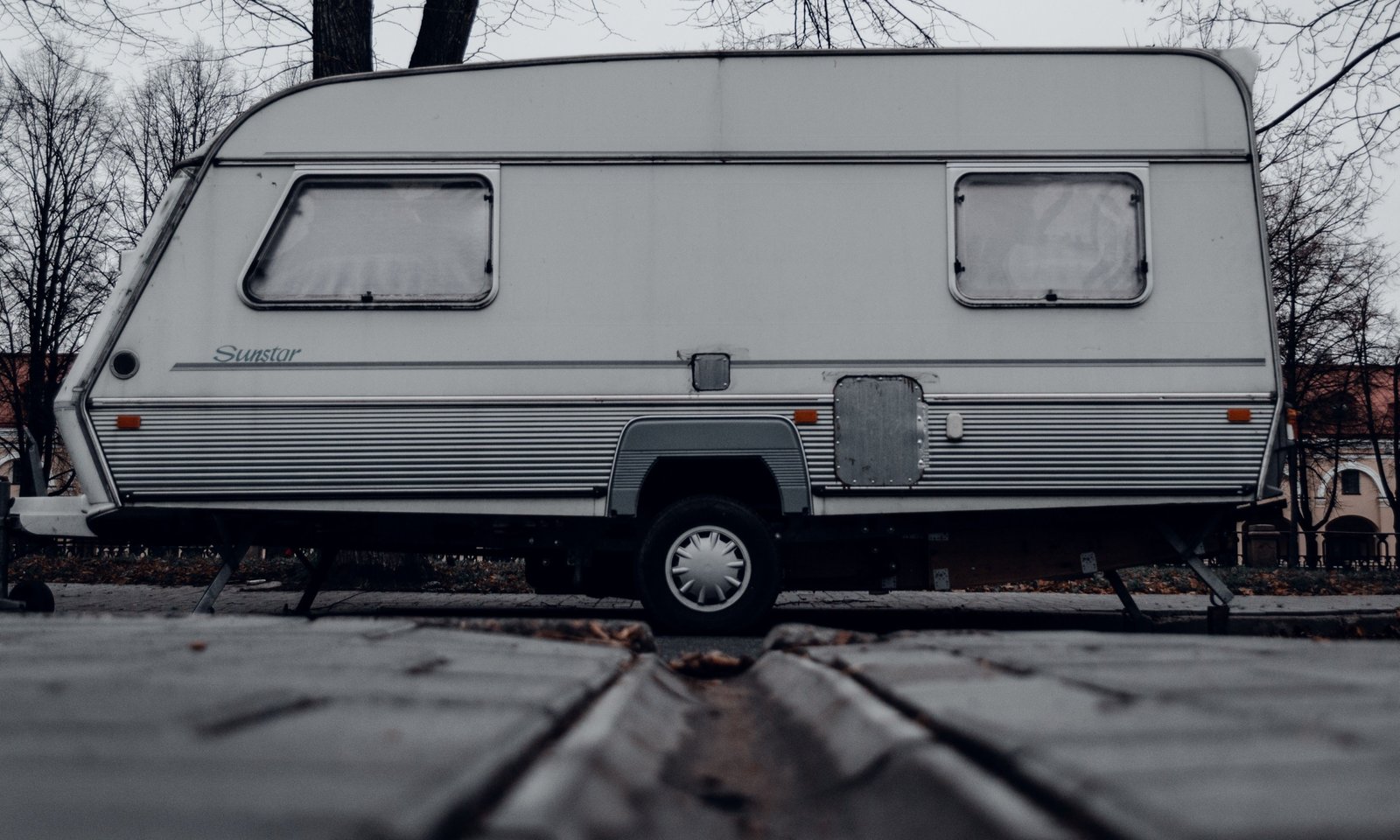 Classic Shasta retro travel trailer parked in nature, showcasing vintage aluminum exterior and cozy camping setup