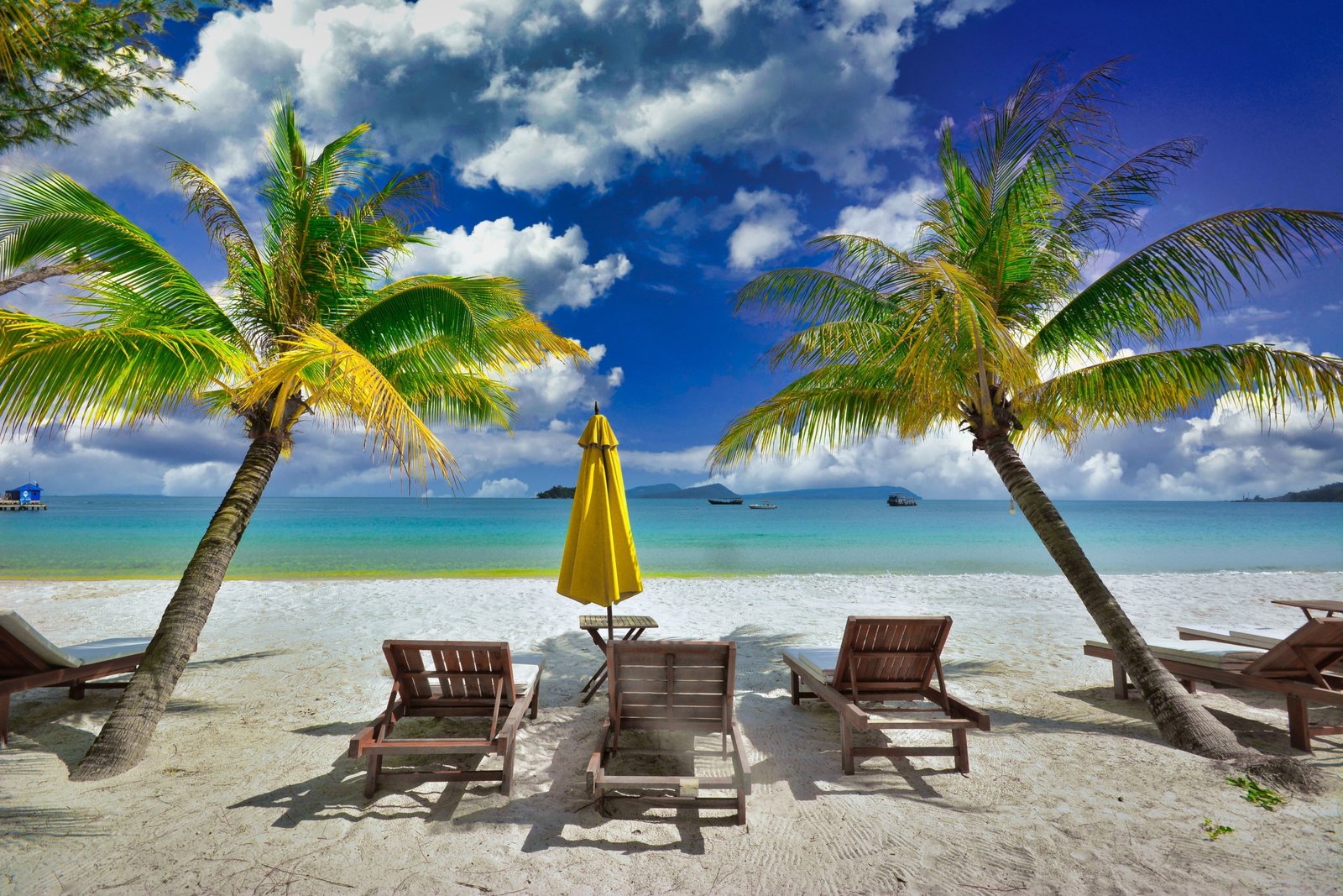 Sunlit tropical beach in Southeast Asia with clear skies and palm trees, perfect travel destination during dry season