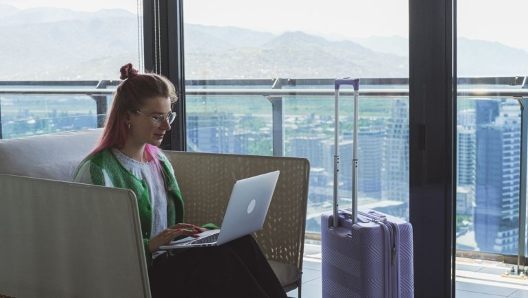 Board Certified Behavior Analyst working remotely while traveling, showcasing flexible travel BCBA job lifestyle