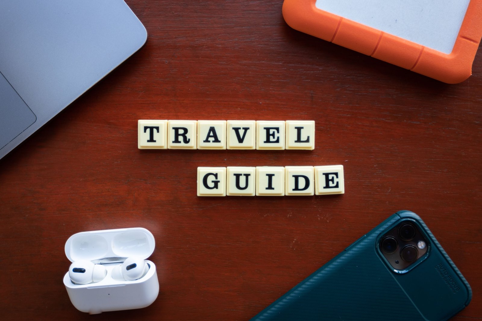 Traveler using AI travel planning tools on laptop and smartphone for personalized itinerary