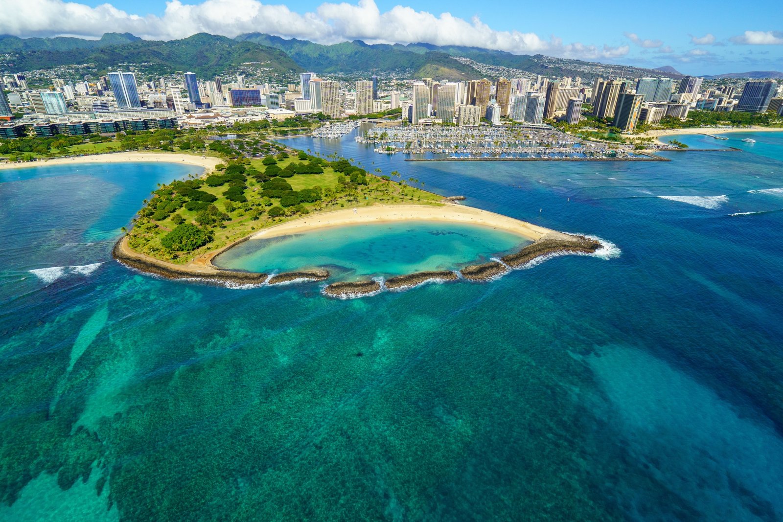 Traveler reading an Oahu travel guide book with scenic Hawaiian landscape in the background