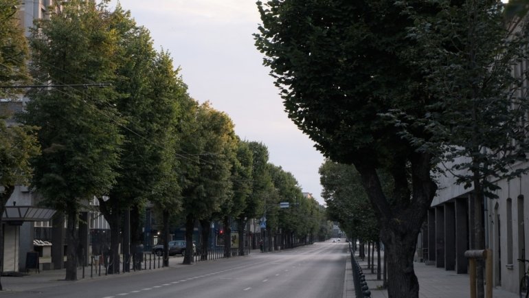 Calm and safe European city street with clean surroundings and happy tourists enjoying peaceful travel