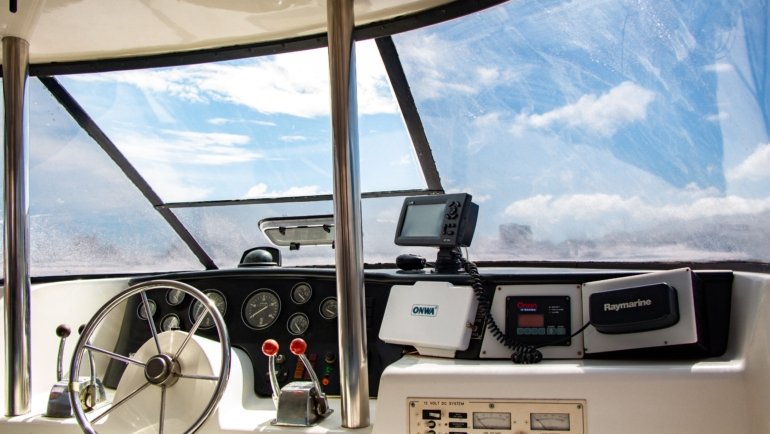 Sailboat cockpit equipped with a dodger and bimini providing sun and weather protection