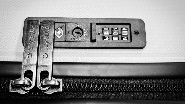 TSA-approved travel luggage lock securing suitcase zipper for safe and secure travel