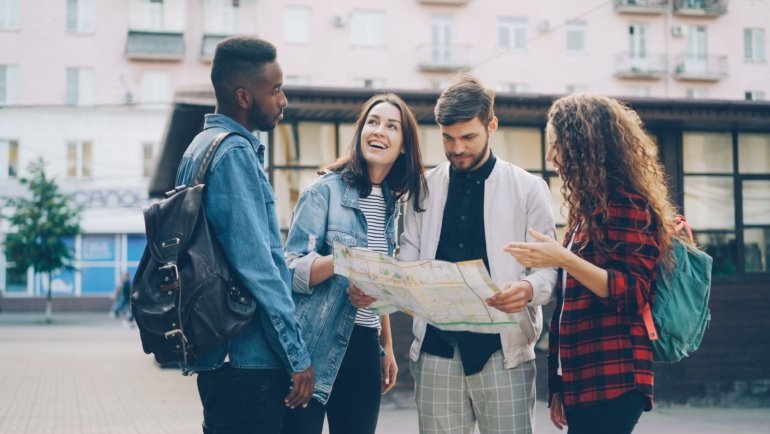 Traveler planning trip with map and Seattle skyline showing Space Needle and waterfront