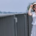 Petite woman dressed in stylish, well-fitting travel outfit with layers, ready for travel and comfortable on the go