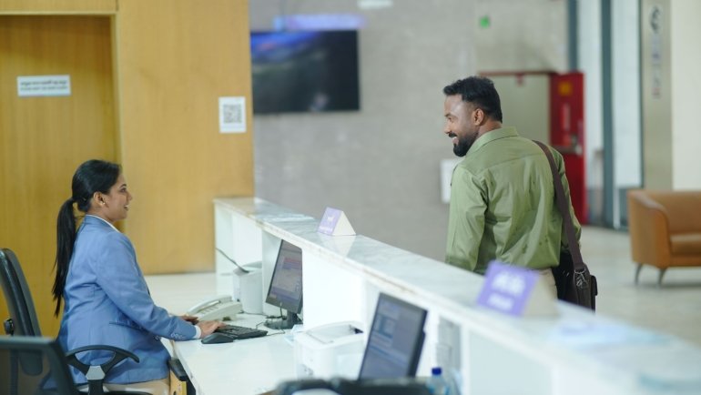 Friendly travel agency staff assisting customers in a modern office for personalized travel planning