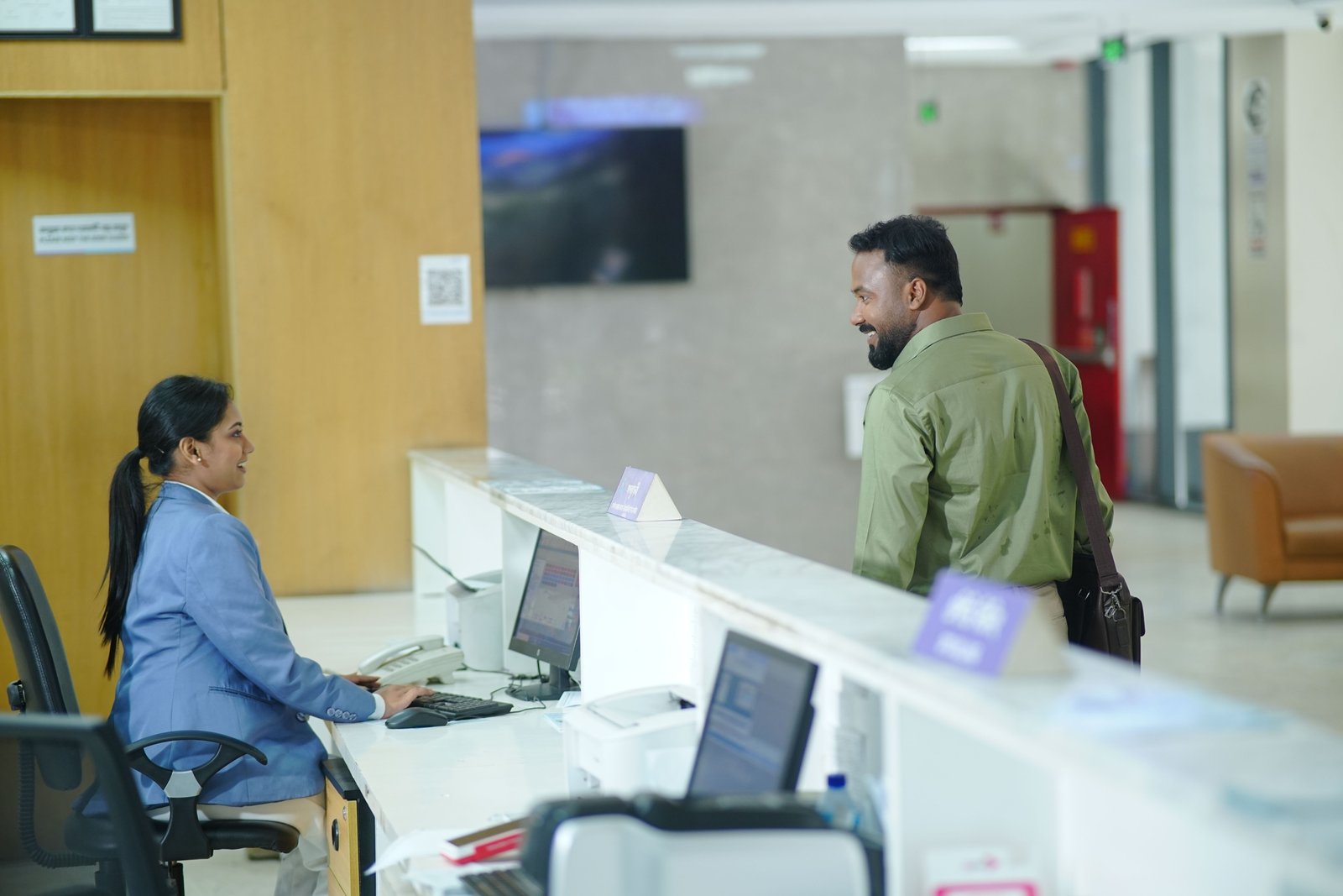 Friendly travel agency staff assisting customers in a modern office for personalized travel planning