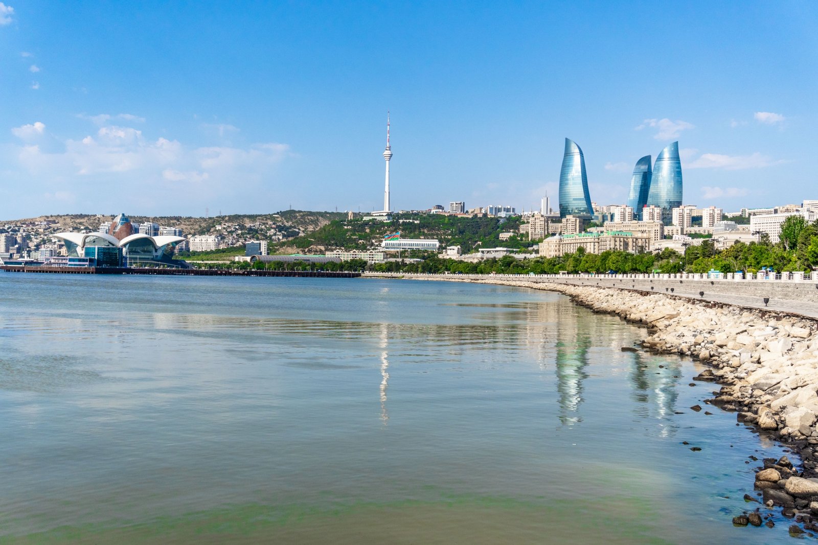 Beautiful scenic landscape of Azerbaijan featuring mountains, Caspian Sea beach, and historic city elements
