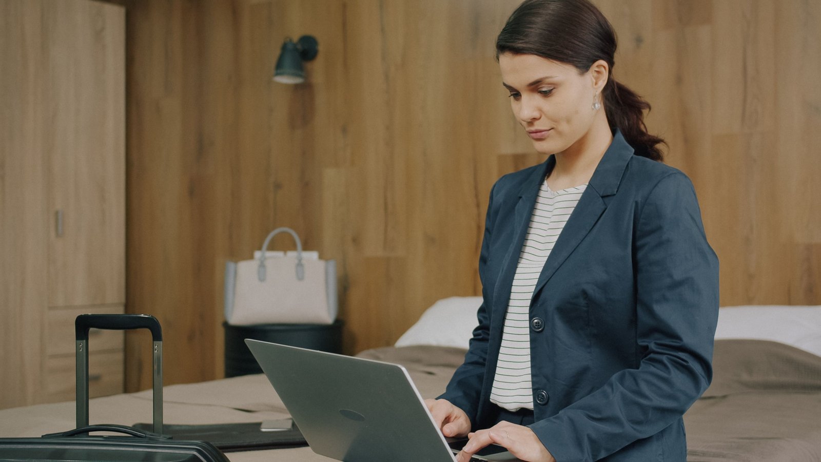 Travel coordinator organizing flights and accommodations on laptop for smooth business travel
