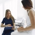 Travel licensed practical nurse providing care to a patient in a healthcare facility