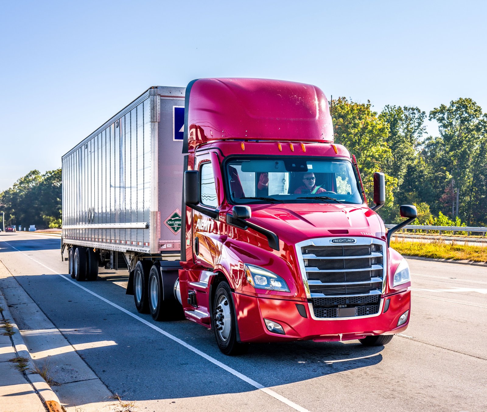 Fully loaded tractor-trailer truck traveling on the highway at 55 mph demonstrating safety and fuel efficiency