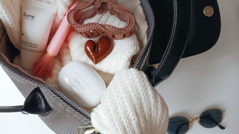 Travel-sized deodorant inside a compact toiletry bag packed for a trip, showcasing essential travel hygiene products